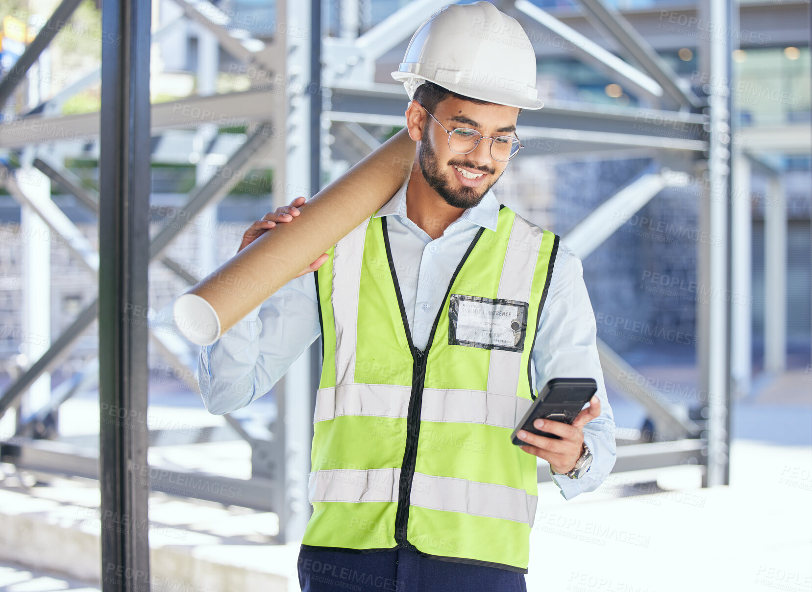 Buy stock photo Architecture, phone typing and happy man with blueprint at construction site, networking and communication with text. Engineering, cellphone and checking email with safety and planning with smile.