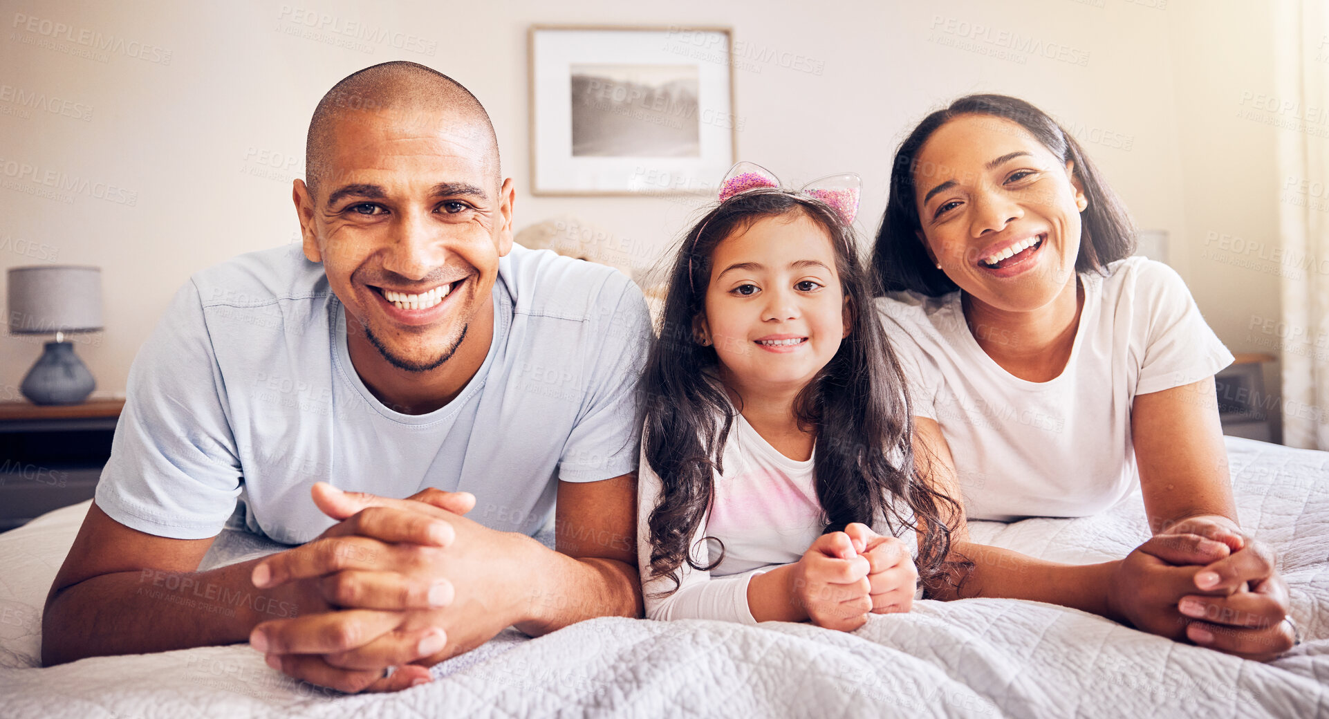 Buy stock photo Family, relax and portrait on a bed at home while happy and together for quality time. Man, woman or hispanic parents and a girl kid in the bedroom for morning bonding with love, security and care
