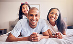 Portrait, happy and a family relax on a bed at home while laughing and playing for quality time. Man, woman or hispanic parents and kid together in the bedroom for morning bonding with love and care