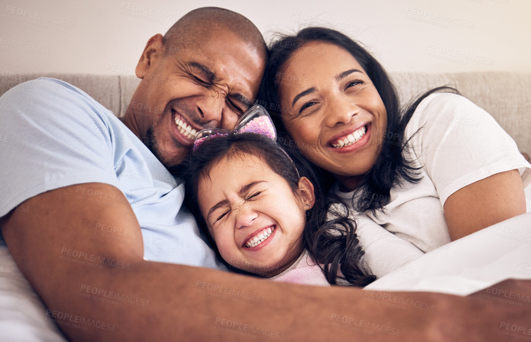 Buy stock photo Family, hug and happy on a bed at home with a smile, comfort and security for quality time. Man, woman or latino parents and a girl kid together in the bedroom for morning bonding with love and care