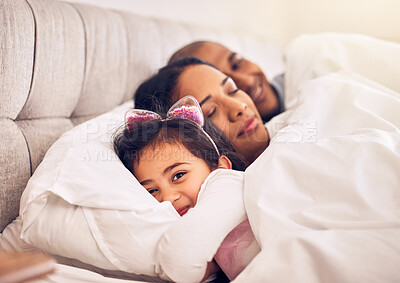 Buy stock photo Family, portrait of a girl in bed with her parents and morning with adorable little child in the bedroom at home. Face, smile or happy with a young female kid in the house to relax with mom and dad