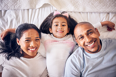 Buy stock photo Mother, father and portrait of a child on a bed in a family home with a smile and comfort for quality time. Above a man, woman and a girl kid together in the bedroom for morning bonding with love