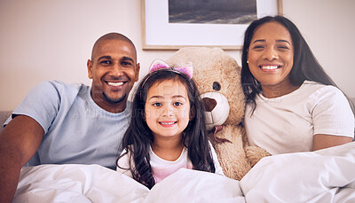Buy stock photo Family, morning and happy portrait on a bed at home with a smile, teddy bear and comfort for quality time. Man, woman or parents and a girl kid together in the bedroom for bonding with love and care