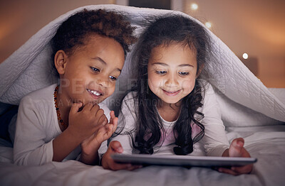 Buy stock photo Happy, night and children with a tablet in bed for cartoon, movie or streaming a show. Smile, blanket and girl kids with technology in the bedroom for the internet, education or online fun together