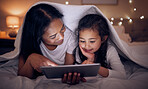 Mother, child and tablet with blanket at night in home for online games, reading ebook story and movies. Happy mom, girl kid and streaming cartoon on digital technology, media connection and bedroom