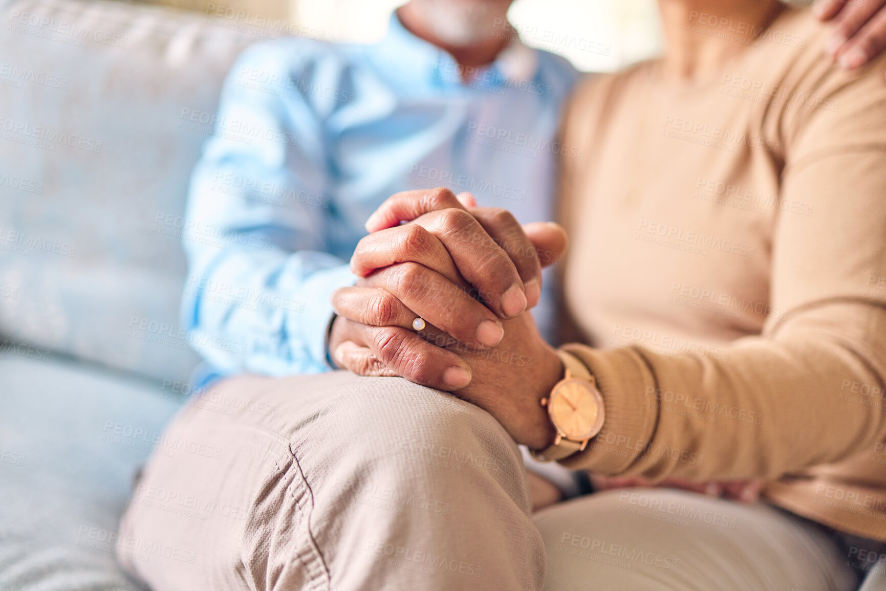 Buy stock photo Love, support and a senior couple holding hands while sitting on a sofa in the living room of their home during retirement. Trust, relax or affection with an elderly man and woman bonding together