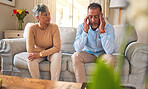 Senior couple, argument and divorce in stress, conflict or fight from disagreement on living room sofa at home. Elderly man and woman in depression, infertility or toxic relationship in the house