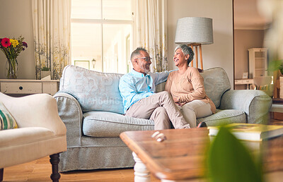 Buy stock photo Couch, love and senior couple relax and laugh together in a home for a conversation and bonding on retirement. Elderly man and woman in a living room for happiness, joke and happy in a marriage
