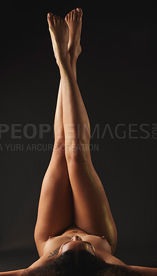 Buy stock photo Body, legs and a nude woman in studio on a black background for beauty or feminine skincare. Upside down, skin and a naked female model posing on a dark backdrop for artistic desire or sensuality