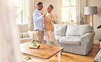 Love, retirement and dance with a senior couple in the living room of their home together for bonding. Marriage, romance or bonding with an elderly man and woman dancing in the lounge of their house