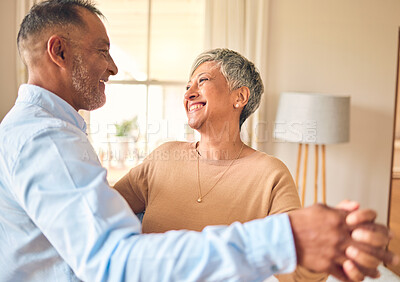 Buy stock photo Love, marriage and dance with a senior couple in the living room of their home together for bonding. Romance, retirement or bonding with an elderly man and woman dancing in the lounge of their house