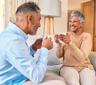 Buy stock photo Coffee, retirement and a senior couple on a sofa in the home living room to relax while bonding in conversation. Smile, love or marriage with a mature man and woman talking while drinking a beverage