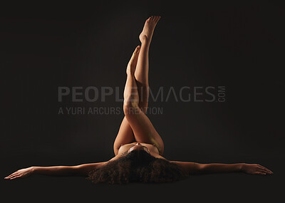 Buy stock photo Body, legs and a naked woman in studio on a black background for beauty or feminine skincare. Upside down, skin and a female nude model posing on a dark backdrop for artistic desire or sensuality