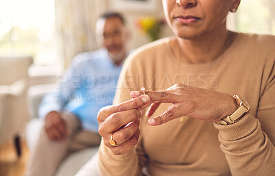 Buy stock photo Senior woman, hands and ring in divorce, fight or conflict from disagreement or argument on sofa at home. Elderly couple in depression, infertility or cheating, mistake or toxic marriage in the house