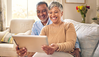 Buy stock photo Tablet, video call and senior couple at home for communication, network connection or chat. Mature man and woman together with technology, social app and internet while laughing on a living room sofa