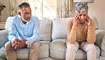 Senior couple, divorce and fight in conflict, argument or disagreement on living room sofa at home. Elderly man and frustrated woman in depression, infertility or toxic relationship in the house