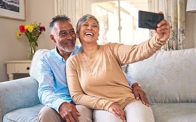 Buy stock photo Senior couple, selfie and laughing at home for social media, network connection or memory. Mature man and woman together with smartphone for a profile picture with a smile and love on a lounge sofa