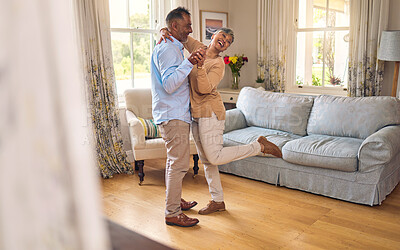 Buy stock photo Love, funny and dance with a senior couple in the living room of their home together for bonding. Marriage, retirement or romance with an elderly man and woman laughing in the lounge of their house