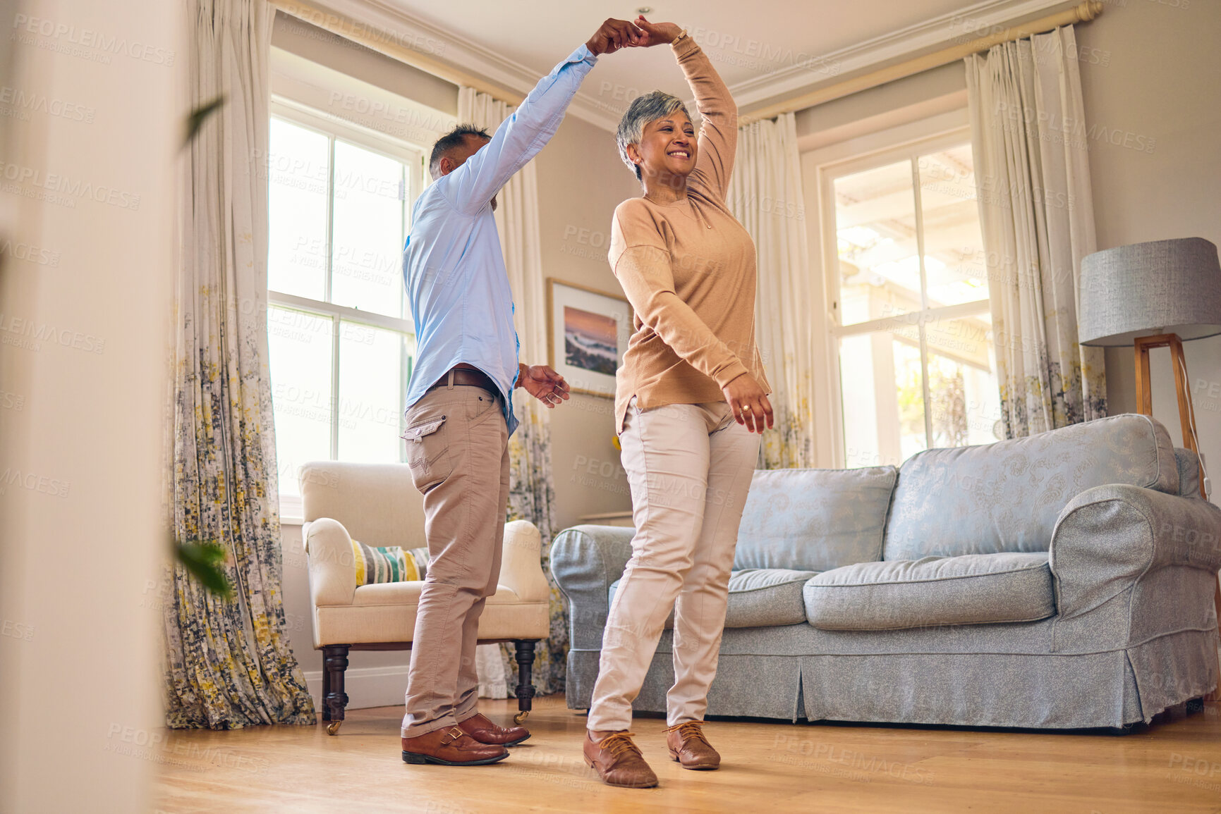 Buy stock photo Retirement, romance and dance with a senior couple in the living room of their home together for bonding. Marriage, love or fun with an elderly man and woman dancing in the lounge of their house