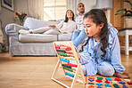 Child, family home and learning with abacus on the floor or mom, dad and girl relax in living room with a game. Kid, development in math and toys for education and couple together on couch in house