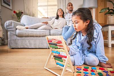 Buy stock photo Child, family home and learning with abacus on the floor or mom, dad and girl relax in living room with a game. Kid, development in math and toys for education and couple together on couch in house