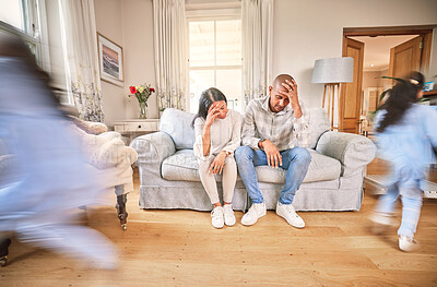Buy stock photo Motion blur, stress and parents with adhd children on a sofa in the living room of their home feeling burnout. Family, kids running or playing with a mom and dad eyes closed in a house for a break