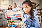 Child, toys for learning and education in family home with abacus on the floor or mom, dad and girl relax in living room with a game. Kid, development in math and couple together on couch in house