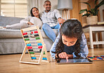 Child, toys for learning and tablet for education in family home with abacus on the floor with mom, dad in living room with a game. Girl, development in math and couple together on couch in house