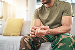 Hands, soldier on sofa and military man with anxiety, depression or problem in home living room. Army person, couch and ptsd, stress or crisis after war, trauma and waiting in lounge alone in house.