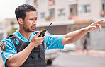 Asian man, police and pointing with walkie talkie in city for emergency dispatch, arrest or calling suspect. Male person, cop or law enforcement with radio signal for communication or safety in town