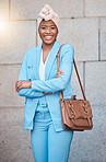 Confidence, success and portrait of businesswoman with crossed arms in the city by her office building. Smile, happy and professional young African female lawyer with a briefcase in an urban town.