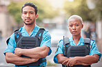 People, police and arms crossed in city for law enforcement, safety and protection outdoors. Portrait of man and woman cop or security guard in teamwork to protect and serve the community in town