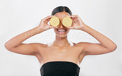 Buy stock photo Indian woman, portrait with lemon for beauty, skincare and natural cosmetics for healthy glow, citrus or vitamin c. Face, eyes and skin care with fruit for wellness, health and white background