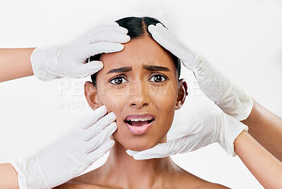 Buy stock photo Plastic surgery, scared and face of woman with hands of prp doctors on white background in studio. Beauty, portrait and indian female model with fear, stress and anxiety for facial aesthetic change