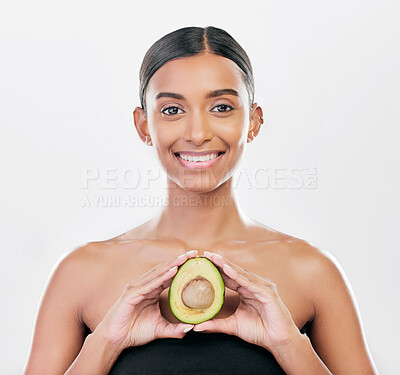 Buy stock photo Woman, beauty and avocado in studio portrait for health, wellness and diet for facial glow by white background. Girl, model and healthy skin with fruit, makeup or cosmetics for self care with smile