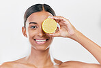 Happy, lemon and portrait of a woman for nutrition, beauty glow or vitamin c for skincare. Smile, wellness and an Indian model or girl with fruit for diet isolated on a white background in a studio