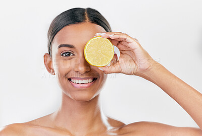 Buy stock photo Happy, lemon and portrait of a woman for nutrition, beauty glow or vitamin c for skincare. Smile, wellness and an Indian model or girl with fruit for diet isolated on a white background in a studio