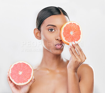 Buy stock photo Indian woman, portrait with grapefruit for beauty, skincare and natural cosmetics for healthy glow, citrus or vitamin c. Face, emoji and skin care with fruit for wellness, health and white background