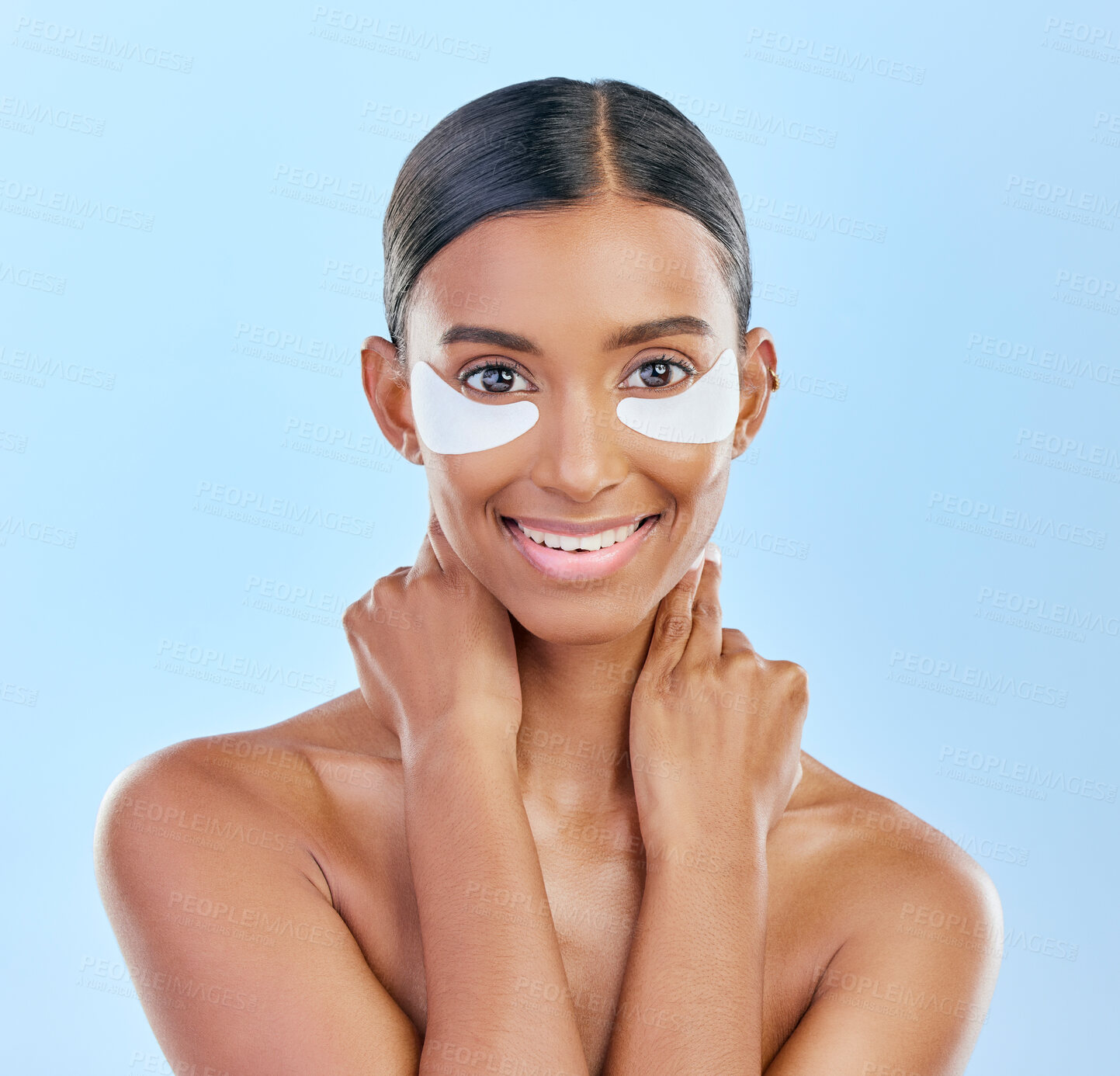 Buy stock photo Eye patch, portrait and beauty of a woman with natural skin glow on a blue background. Dermatology, collagen face mask and cosmetics of Indian female model for facial shine and self care in studio