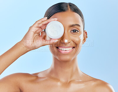 Buy stock photo Cream, container and beauty, woman with skincare and cosmetics product isolated on blue background. Lotion on face, sunscreen and facial mask, smile and moisturizer with female model and dermatology