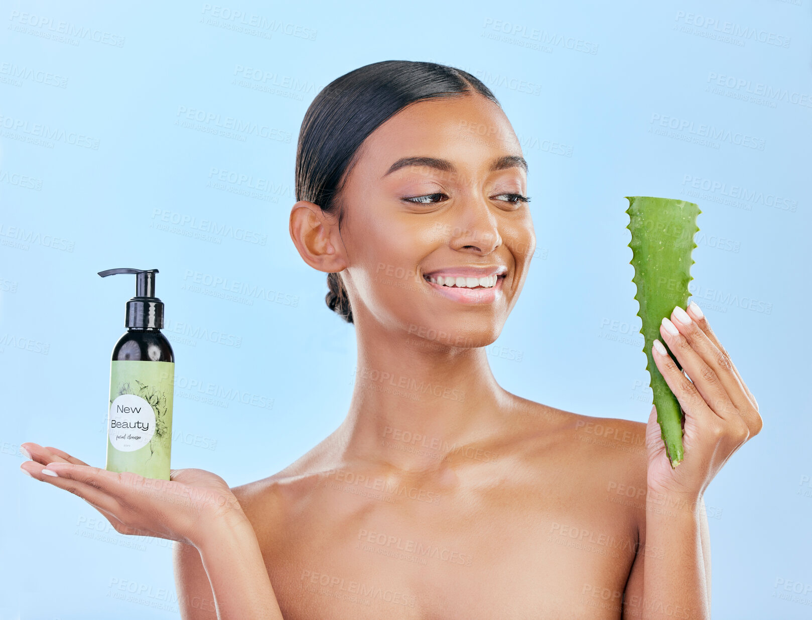 Buy stock photo Woman, aloe vera and skincare in studio with smile, natural choice and happy by blue background. Girl, model and cactus plant for health, wellness and bottle with serum for self care, facial and glow