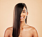 Hair care, smile and portrait of a woman on a studio background with salon treatment. Beauty, happy and headshot of an Indian model or girl showing healthy shampoo results isolated on a backdrop