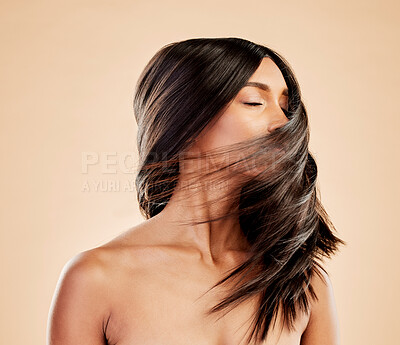 Buy stock photo Woman, beauty and shake hair in studio for aesthetic shine, volume and smooth shampoo results. Indian female model, salon treatment and wind in hairstyle for growth, soft texture and cosmetic care