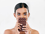 Woman, portrait and chocolate in sweet diet or unhealthy eating against a white studio background. Female person or model with cocoa slab, block or bar in delicious treat, snack or diabetes on mockup