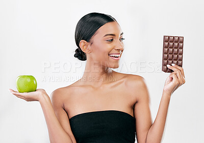 Buy stock photo Apple, chocolate and woman with healthy food choice or offer isolated on studio, white background for sugar and diet. Dessert, green fruit and young person with detox, vegan or lose weight decision