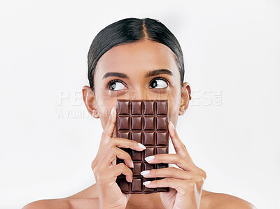 Buy stock photo Woman, thinking and chocolate in sweet diet or unhealthy eating against a white studio background. Female person or model with cocoa slab, block or bar in delicious treat, snack or diabetes on mockup