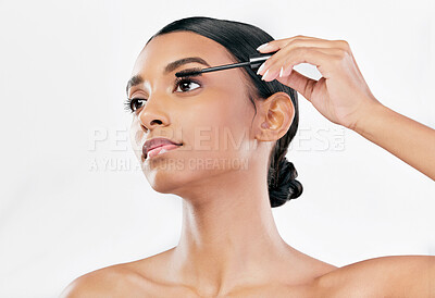 Buy stock photo Beauty, mascara and makeup of a woman with natural glow isolated on a white background. Eyelash, cosmetics and lash brush of Indian female model for facial shine, application and self care in studio