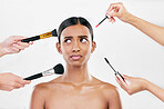 Makeup, brush and confused woman with beauty shine, overwhelmed with beautician on white background. Anxiety with cosmetics, tools and hands crowd female model in studio, cosmetology and skin glow