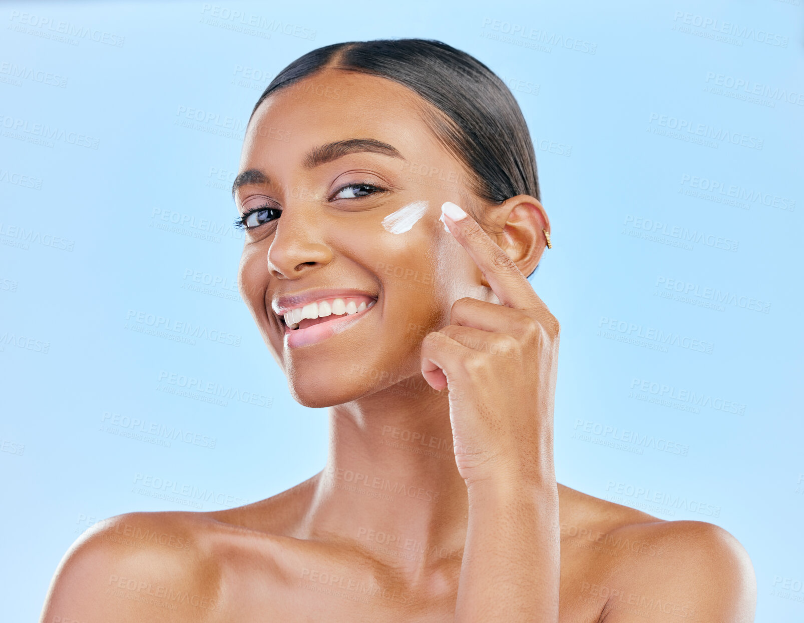 Buy stock photo Face, cream and beauty, woman in portrait with skincare and cosmetics product isolated on blue background. Lotion, sunscreen and facial mask, smile and moisturizer with female model and dermatology