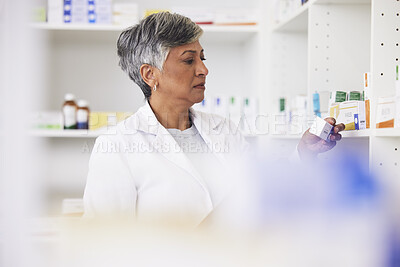 Buy stock photo Pharmacist, shelf and a woman reading a medicine box label in a pharmacy for knowledge. Mature female employee in healthcare, pharmaceutical and medical industry to check product information on stock